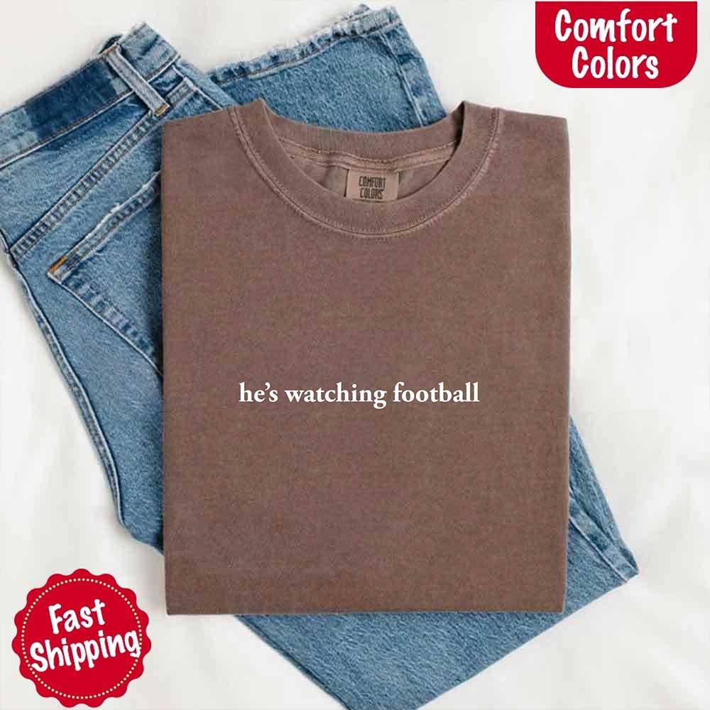 He’s Watching Football Tee - Comfort Colors Funny Shirt for Her