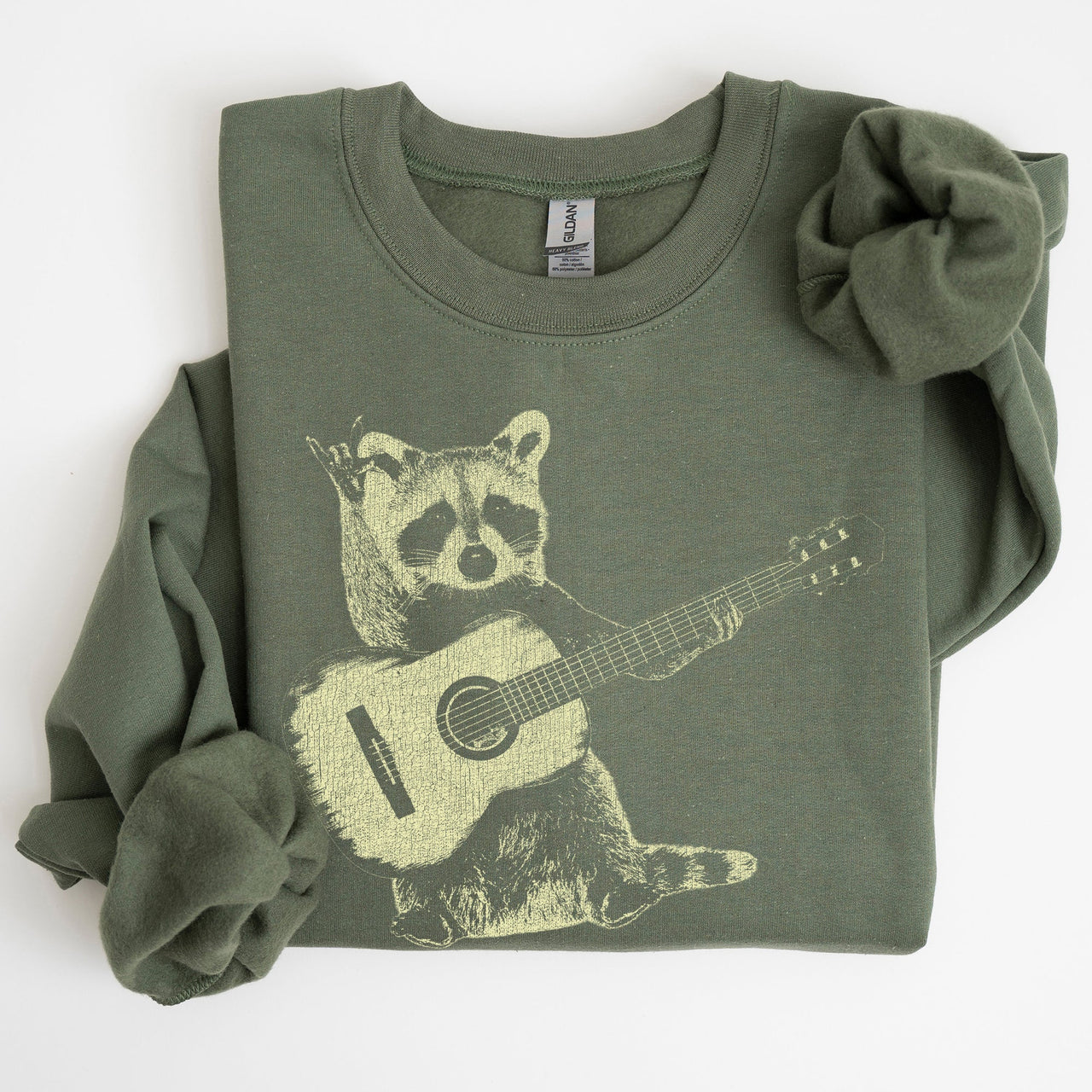 Raccoon Playing A Guitar In A Whimsical Forest Scene With Playful Vibe Sweatshirt