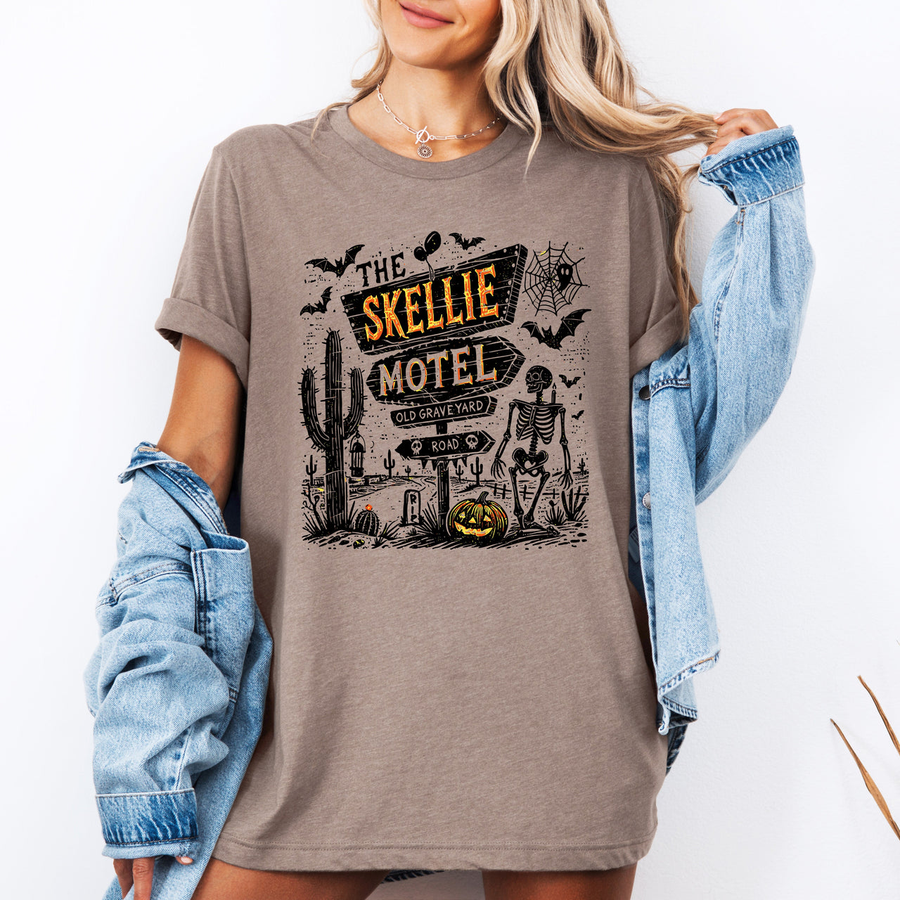 The Skellie Motel Graphic Tee Featuring Skeleton Halloween Artwork Perfect For Spooky Season