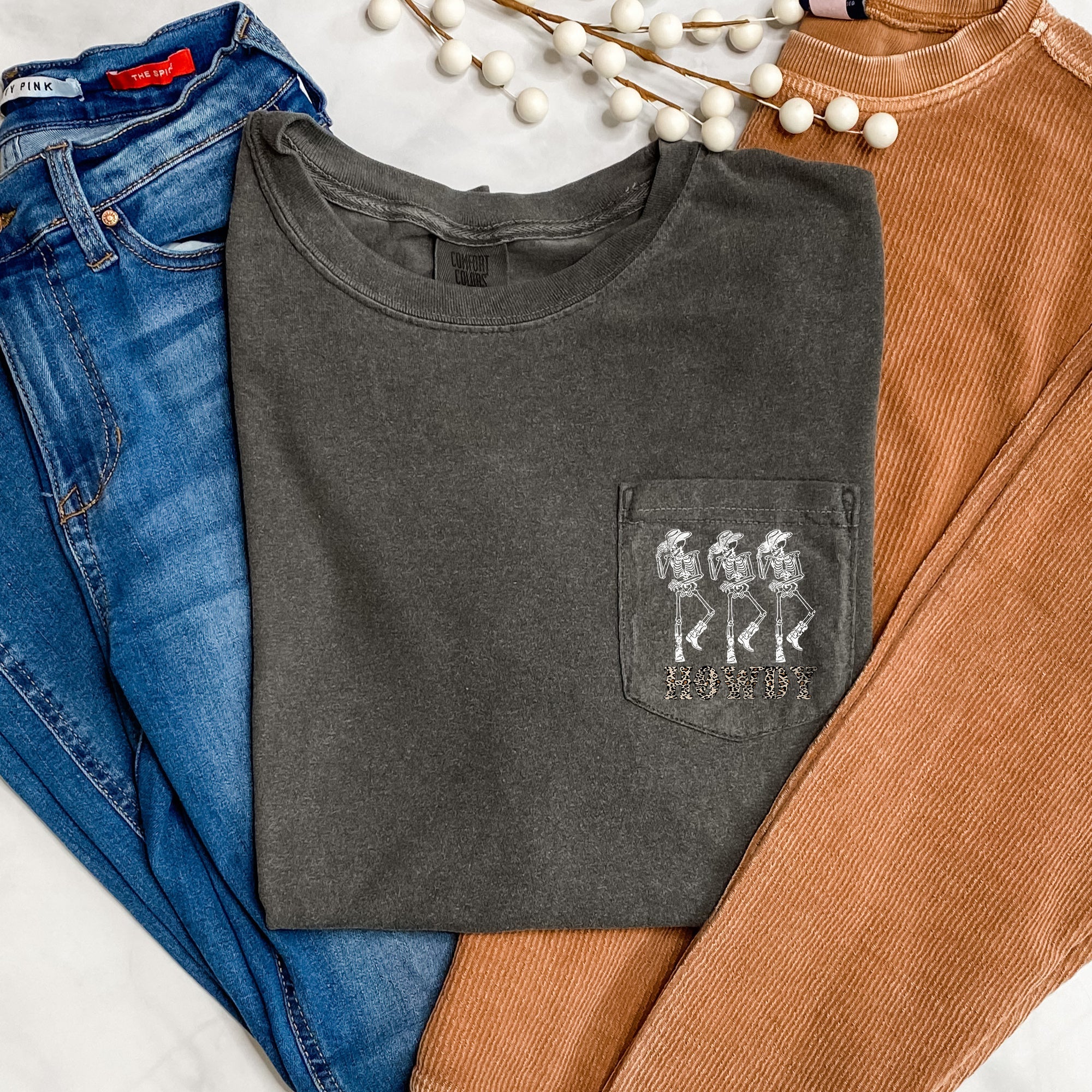 Howdy Skeletons Leopard Halloween Pocket Print With Western Style Skeletons In Leopard Spots At Dusk Comfort Colors Tee